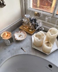 a bathroom with a sink, candles, and a candle holder