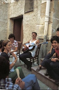 a group of people sitting on steps and playing music